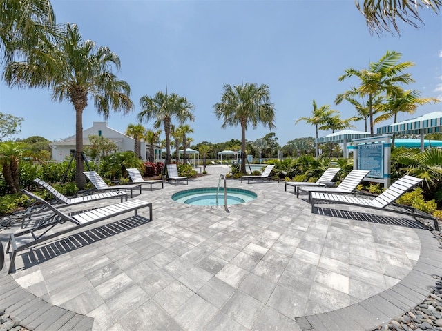 view of swimming pool featuring a hot tub and a patio