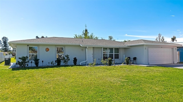 single story home with a garage, driveway, a front yard, and stucco siding