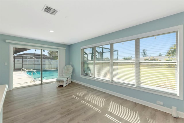 unfurnished sunroom featuring visible vents