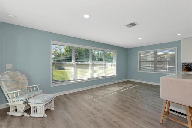 interior space with recessed lighting, wood finished floors, visible vents, and baseboards