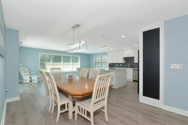 dining area with baseboards, recessed lighting, and light wood-style floors