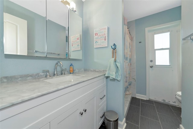 bathroom featuring toilet, a shower with curtain, tile patterned flooring, and vanity