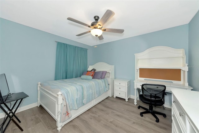 bedroom featuring baseboards, ceiling fan, and light wood finished floors