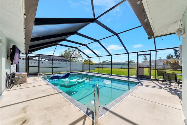 pool with a lanai, a patio area, and a yard