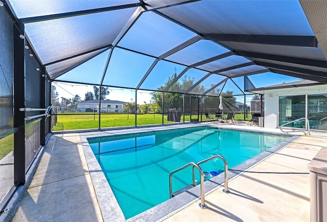 pool with glass enclosure, a lawn, and a patio