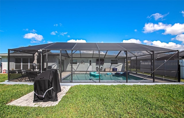 exterior space featuring a lanai, a patio area, an outdoor pool, and a yard