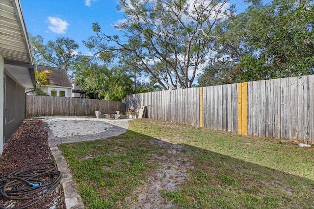 view of yard featuring a patio area and a fenced backyard