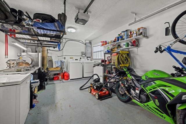 garage featuring a garage door opener, washing machine and dryer, and electric panel