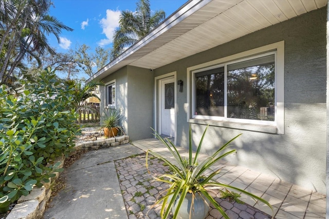 view of side of property featuring a patio area and stucco siding