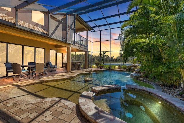 view of swimming pool with a patio area, a lanai, and a pool with connected hot tub