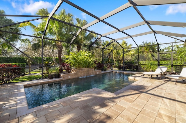 pool with glass enclosure and a patio area