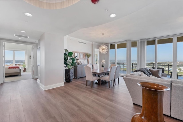 dining room with light wood-type flooring, baseboards, visible vents, and recessed lighting