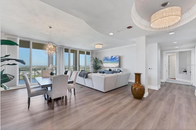 dining space featuring recessed lighting, a notable chandelier, wood finished floors, baseboards, and floor to ceiling windows