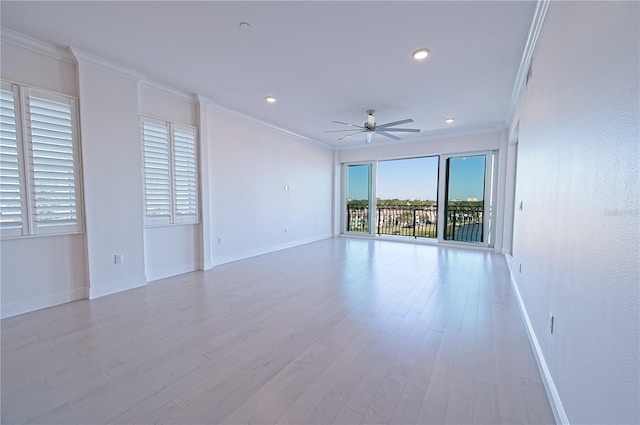 unfurnished room with a ceiling fan, crown molding, baseboards, and wood finished floors