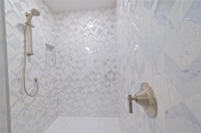 full bath with a tile shower