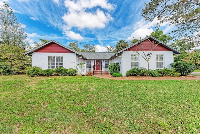 ranch-style house with a front yard, fence, a gate, and stucco siding