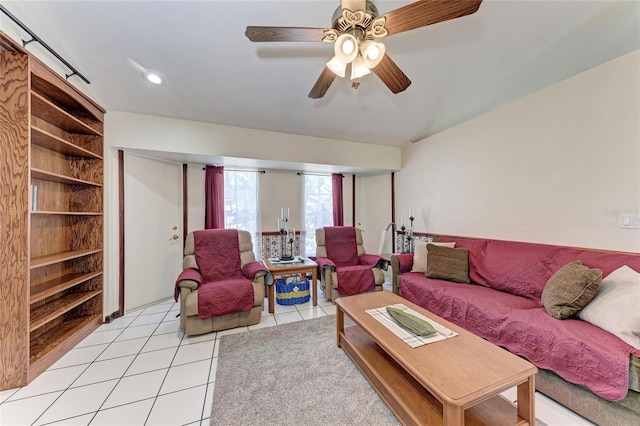 living area featuring light tile patterned floors and ceiling fan