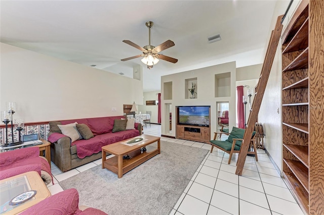 living room featuring light tile patterned floors, lofted ceiling, visible vents, and a ceiling fan