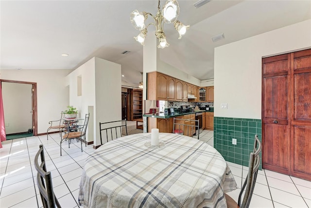 dining area with ceiling fan with notable chandelier, visible vents, and light tile patterned floors