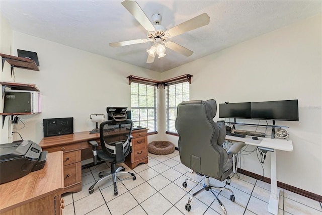 office featuring ceiling fan, baseboards, and light tile patterned floors