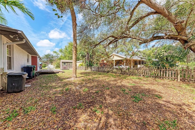 view of yard featuring an outbuilding and fence