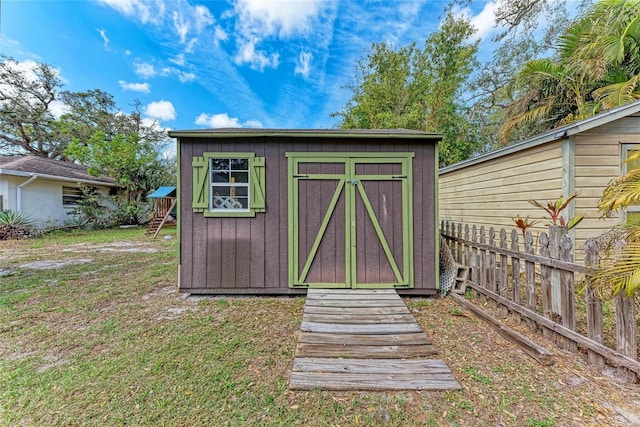 view of shed featuring fence