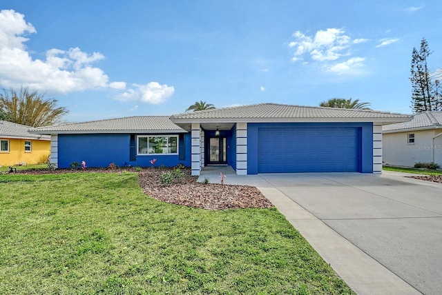 ranch-style home featuring stucco siding, an attached garage, driveway, a tiled roof, and a front lawn