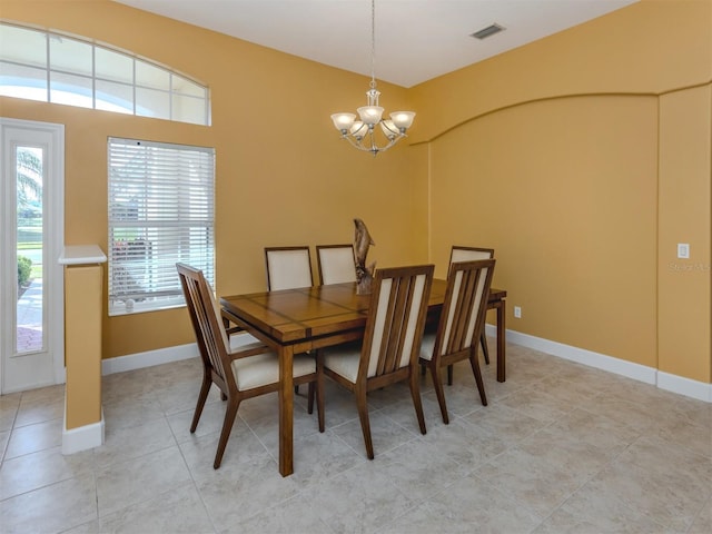 dining room featuring baseboards, light tile patterned flooring, visible vents, and an inviting chandelier