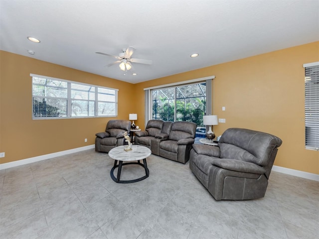 living area featuring baseboards, a ceiling fan, and recessed lighting