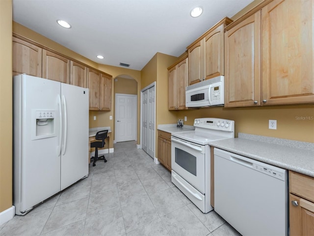 kitchen with arched walkways, light countertops, visible vents, light brown cabinetry, and white appliances