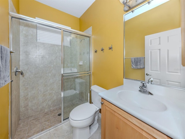 full bathroom featuring vanity, tile patterned flooring, a shower stall, and toilet