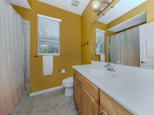 bathroom with baseboards, a shower with shower curtain, toilet, tile patterned floors, and vanity