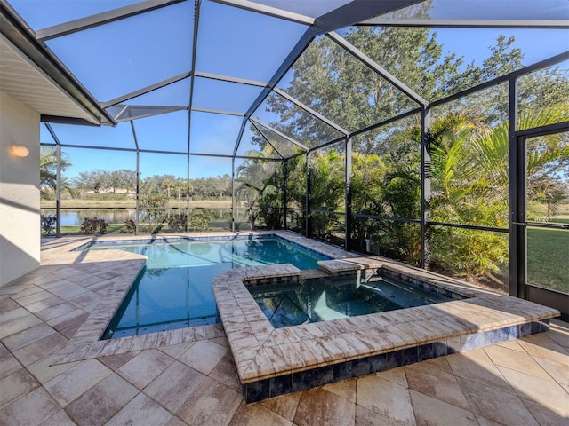 view of pool with a patio area, a lanai, a pool with connected hot tub, and a water view