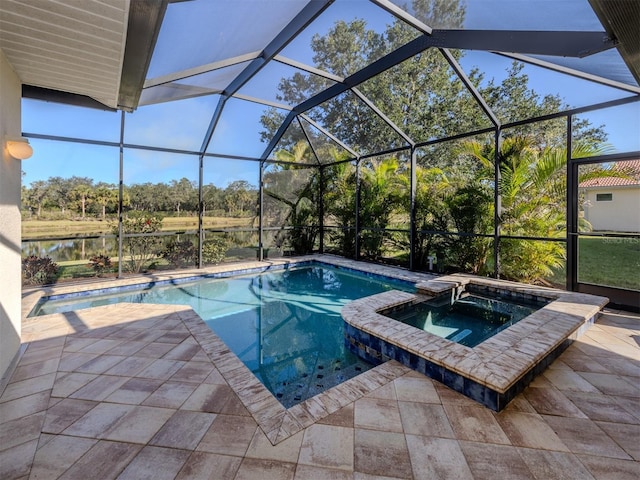 view of pool featuring a patio, glass enclosure, and a pool with connected hot tub