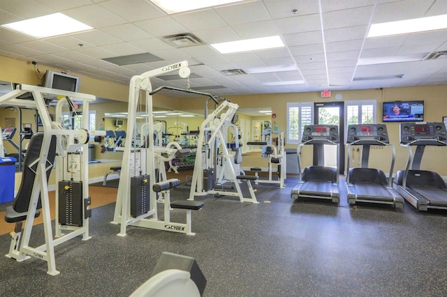 gym featuring a paneled ceiling and visible vents