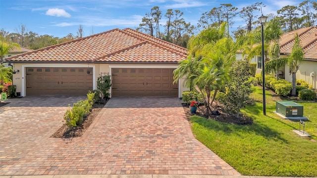 mediterranean / spanish-style house featuring stucco siding, a front lawn, decorative driveway, and a tiled roof