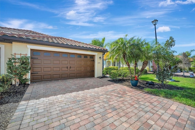 garage with decorative driveway