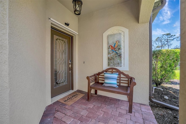 property entrance with stucco siding