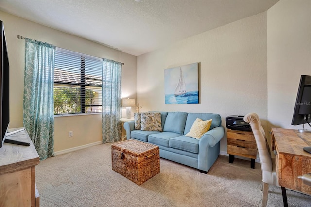 carpeted living area featuring a textured ceiling and baseboards