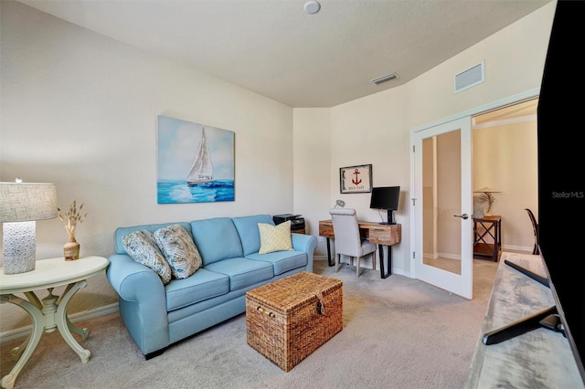 carpeted living room featuring baseboards, visible vents, and french doors