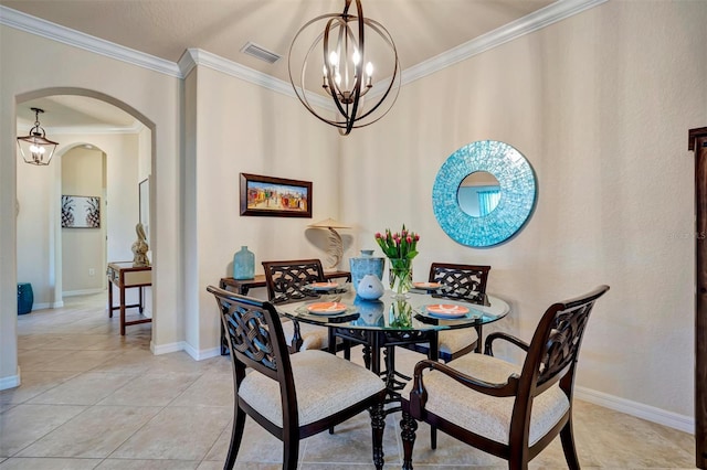 dining room featuring ornamental molding, arched walkways, light tile patterned flooring, and an inviting chandelier