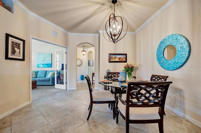 dining room featuring light tile patterned floors, visible vents, arched walkways, and crown molding