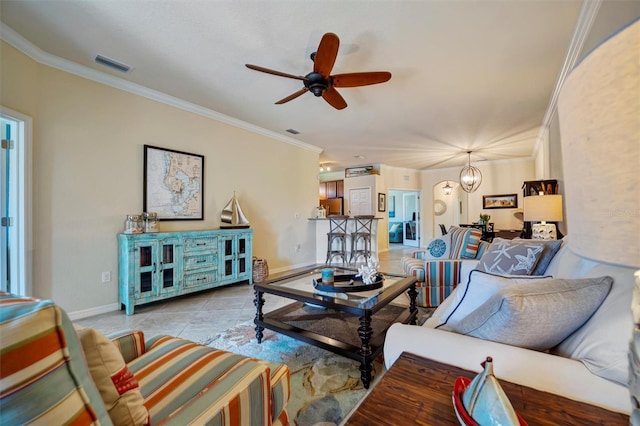 tiled living area featuring baseboards, ceiling fan with notable chandelier, visible vents, and crown molding