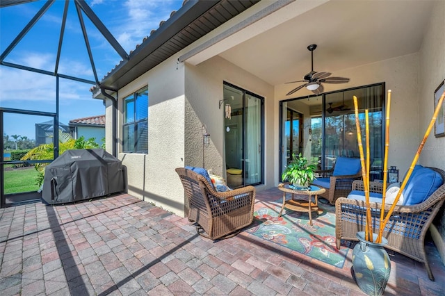 view of patio / terrace with a lanai, a grill, ceiling fan, and an outdoor living space