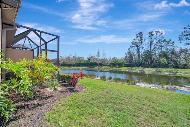 view of yard featuring a lanai and a water view