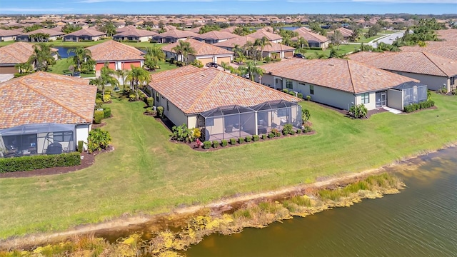 birds eye view of property with a water view and a residential view