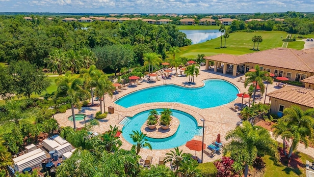 community pool featuring a patio and a water view