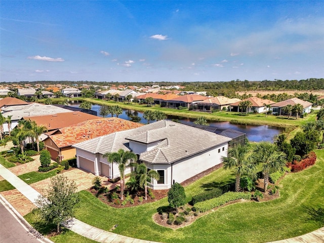 drone / aerial view featuring a water view and a residential view