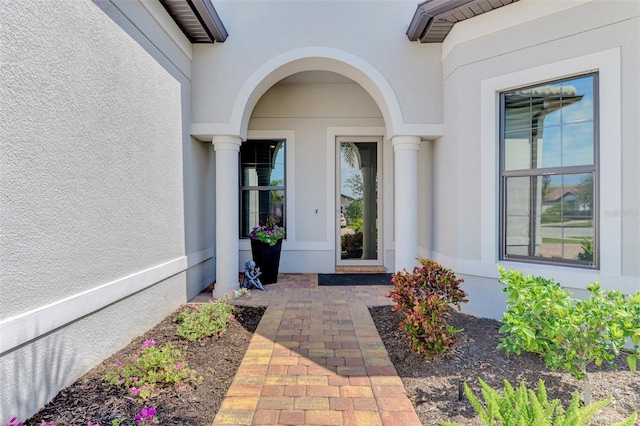 doorway to property with stucco siding