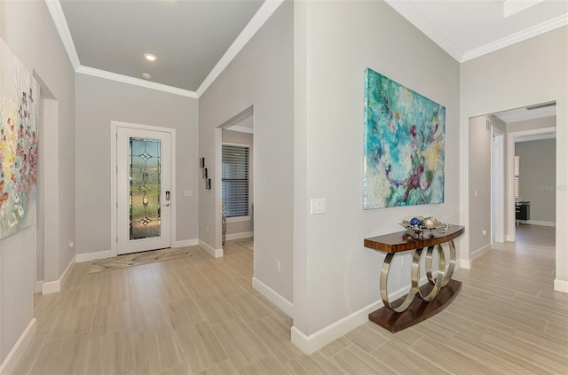 entrance foyer featuring baseboards, light wood-style flooring, visible vents, and crown molding